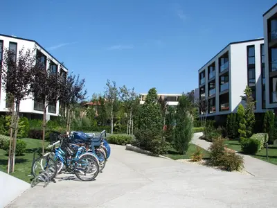 a couple of motorcycles parked in a parking lot at Atlantis Atmosphere Apartment in Burgas City