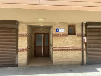 a building with a door and a sign on it at Apartments Pomorie Tundzha 9 in Pomorie