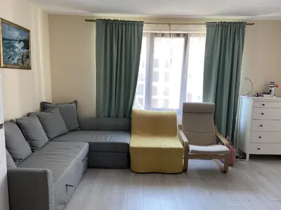 a living room with a couch and a chair at Apartments Pomorie Tundzha 9 in Pomorie
