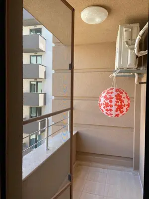 a room with a balcony with a lamp and a building at Apartments Pomorie Tundzha 9 in Pomorie