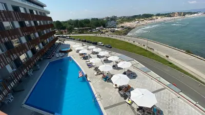 an overhead view of a swimming pool with umbrellas at PARADISO 'В' 408 Private Studio Nessebar in Nesebar