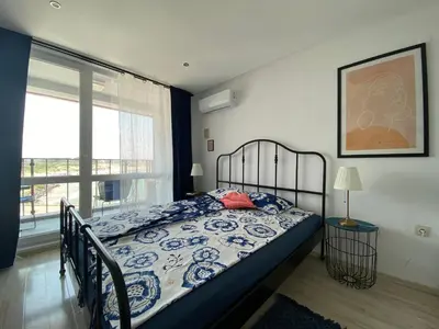 a bedroom with a bed and a large window at PARADISO 'В' 408 Private Studio Nessebar in Nesebar