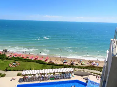 a view of the beach from the balcony of a resort at Бяла Клиф Форест - Byala Cliff Forest in Byala