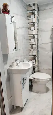 a white bathroom with a sink and a toilet at Apartment 7 in Tsarevo