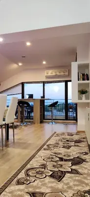an open living room with a large rug on the floor at Apartment 7 in Tsarevo