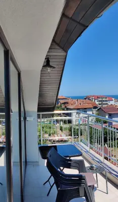 a balcony with chairs and a table and a view at Apartment 7 in Tsarevo