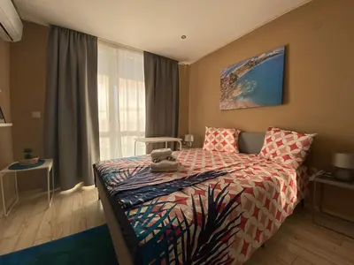 a bedroom with a bed with a stuffed animal on it at PARADISO 'В' 106 Private Cozy Studio NESSEBAR in Nesebar