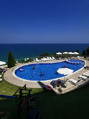 a large swimming pool with chairs and umbrellas at Silver A 27 in Byala
