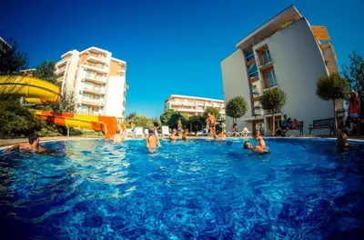 a group of people in a swimming pool at Fort Noks - Menada Apartments in Sveti Vlas
