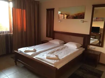 a bedroom with a large bed with a mirror at Casa Real B 5-1 in Sveti Vlas