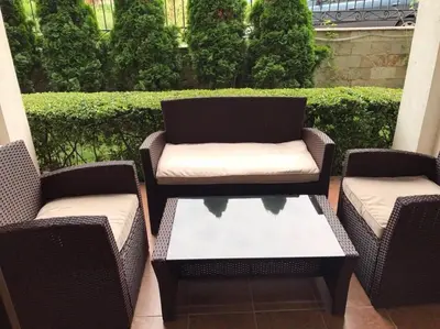 three wicker chairs and a table on a patio at Casa Real B 5-1 in Sveti Vlas