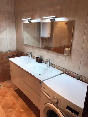 a bathroom with a sink and a washing machine at Casa Real B 5-1 in Sveti Vlas
