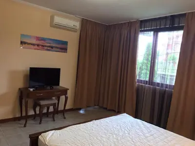 a bedroom with a bed and a desk with a television at Casa Real B 5-1 in Sveti Vlas