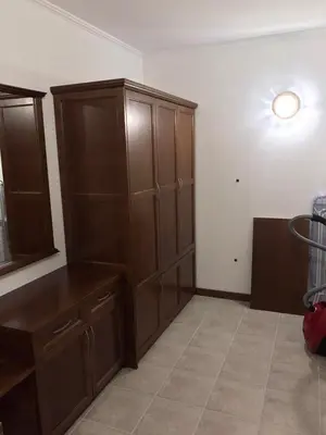a kitchen with a large wooden cabinet in a room at Casa Real B 5-1 in Sveti Vlas