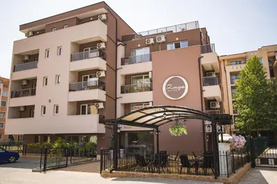 an apartment building with a restaurant in front of it at Hotel Zonya in Sunny Beach