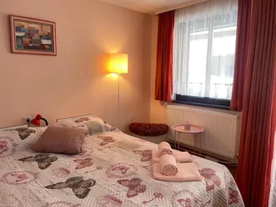 a bedroom with a bed with towels on it at Къща за гости ЕЛЕНИ in Sozopol