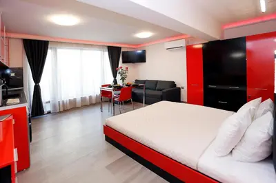 a hotel room with a bed and a living room at Deluxe 2 Studios City Center in Burgas City
