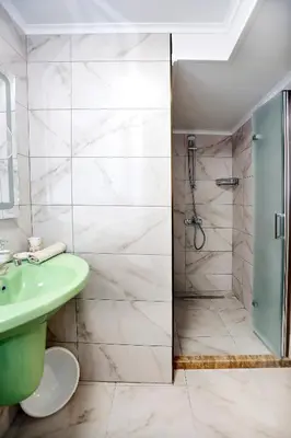 a bathroom with a green sink and a shower at Deluxe 2 Studios City Center in Burgas City
