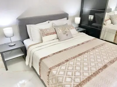 a bedroom with a large bed and two night stands at Modern Apartment for 4 Guests Sea View & Free Parking in Pomorie