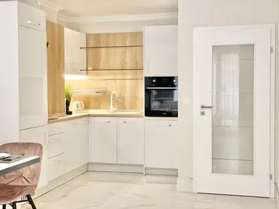 a white kitchen with white cabinets and a sink at Modern Apartment for 4 Guests Sea View & Free Parking in Pomorie
