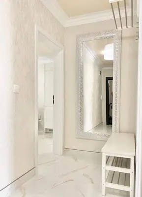 a mirror in a white room with a white stool at Modern Apartment for 4 Guests Sea View & Free Parking in Pomorie