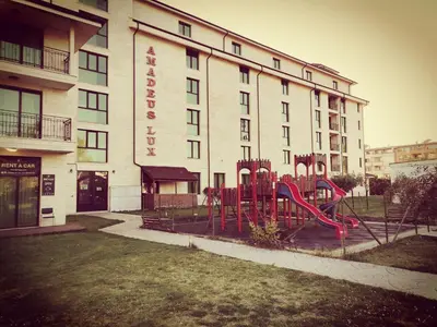 a hotel with a playground in front of a building at Pool Apartment Amadeus Lux in Sunny Beach