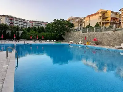 a large swimming pool with blue water at Sun Wave EXCLUSIVE in Sveti Vlas