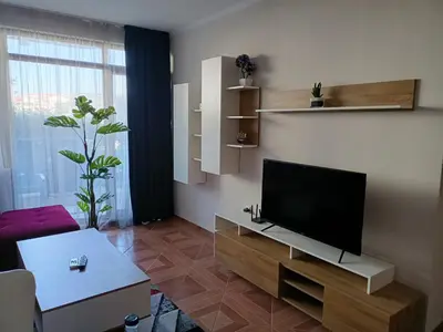 a living room with a flat screen tv on a wall at Sun Wave EXCLUSIVE in Sveti Vlas