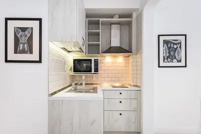 a kitchen with a sink and a microwave at Jazz & Wine - Luxury apARTment By The Sea & Parking & HBO & Netflix in Varna City
