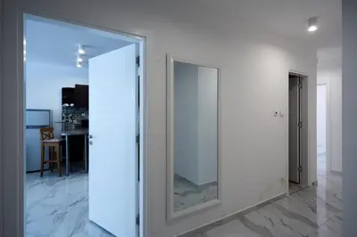 a large glass door in a room with a table at Luxury First Line apartment with pool by the sea in Nesebar