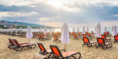 a group of chairs and umbrellas on a beach at AFRODITA I 112 Private Cozy Studio Sunny Beach in Sunny Beach