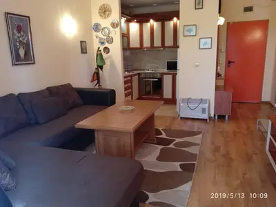 a living room with a couch and a table at Апартамент Златна дюна-Фешева in Nesebar