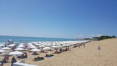 a large group of umbrellas on a beach at Апартамент Златна дюна-Фешева in Nesebar