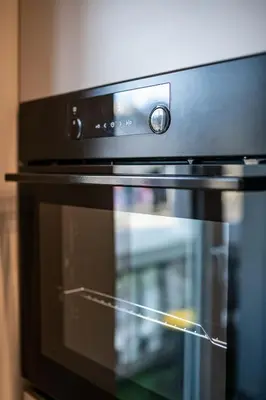 a close up of an oven with its door open at Smart Central Apartment in Varna City