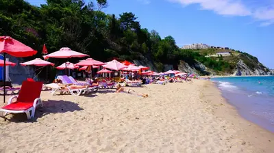 a group of people sitting on a beach with umbrellas at Byala Vista Beach Apartments D - Бяла Виста Бийч Апартментс Д in Byala