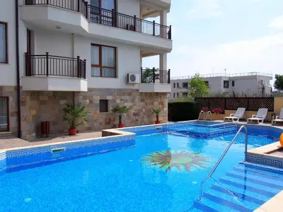 a large swimming pool in front of a building at Byala Vista Beach Apartments D - Бяла Виста Бийч Апартментс Д in Byala