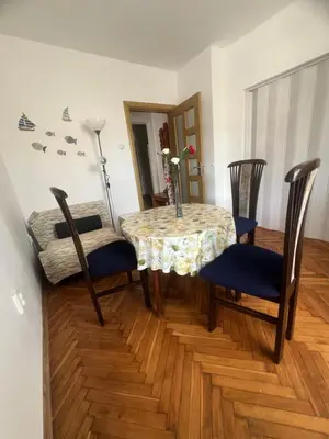 a dining room with a table with chairs and a table and a table and chairs at Апартамент Иванови in Pomorie