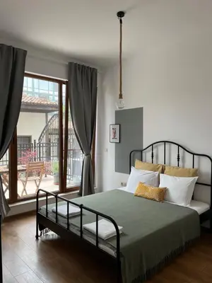 a bedroom with a bed and a large window at Atelier 26 in Varna City