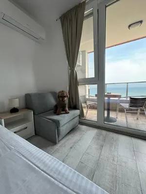a room with a bed and a couch and a window at Апартаменти за гости 
