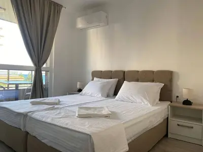 a bedroom with a large bed with two towels on it at Апартаменти за гости 