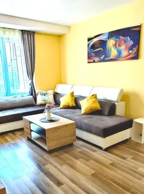 a living room with a couch and a coffee table at Family Apartments Amadeus lux in Sunny Beach