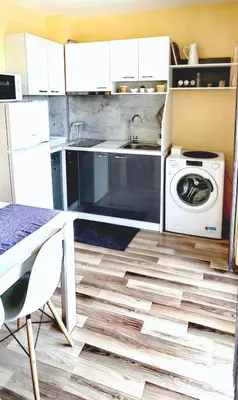 a kitchen with a sink and a washing machine at Family Apartments Amadeus lux in Sunny Beach