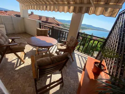 a patio with a table and chairs on a balcony at Sunrise - Apartment 41,Santa Marina, Sozopol in Sozopol