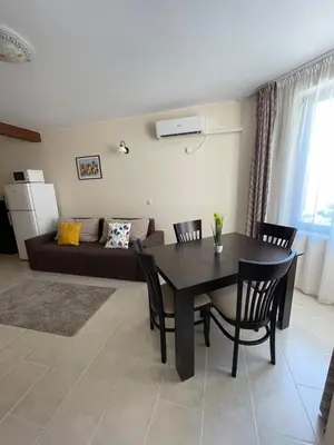 a living room with a table and a couch at Rich-2 SP apartments in Ravda