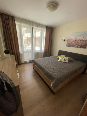 a bedroom with a bed and a large window at Rich-2 SP apartments in Ravda