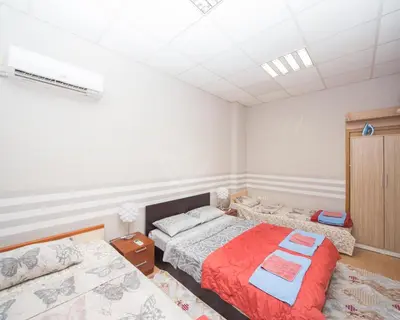 a room with two beds in it with avertisement for at Summer Downtown - Compact Basic Flat - 1st floor in Burgas City