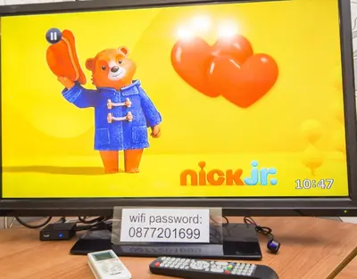 a computer monitor with a toy of a bear with balloons at Summer Downtown - Compact Basic Flat - 1st floor in Burgas City