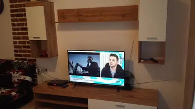 a flat screen tv sitting on top of a wooden table at Apolon 2 in Sozopol