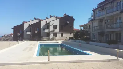 a swimming pool in front of some buildings at Apolon 2 in Sozopol