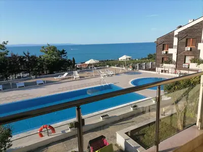 a view of the swimming pool from the balcony of a house at Apolon 2 in Sozopol